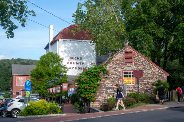 New Hope, USA - June 26, 2021. People walking on sidewalk by Bucks County Playhouse, New Hope, Pennsylvania, USA