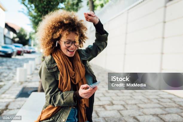 Portrait Of A Happy Girl Dancing With Her Favorite Song Stock Photo - Download Image Now