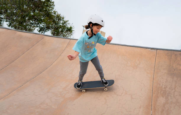 girl skating in park caucasian girl skateboarding in a skate park extreme dedication stock pictures, royalty-free photos & images