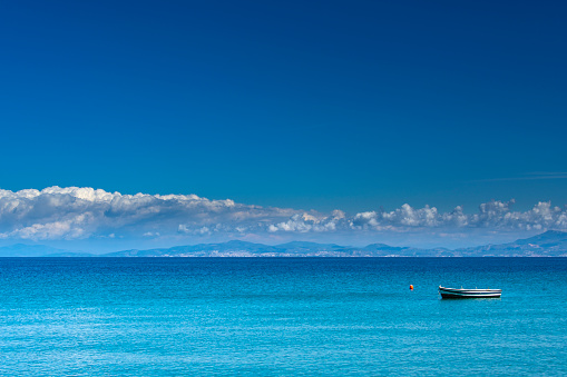 Small fishing boat in a turquoise Mediterrenean Sea.