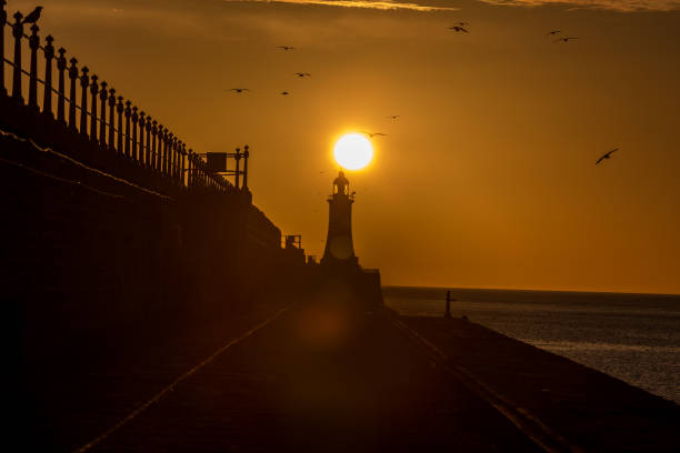 istock Tynemouth Pier and the Lighthouse with a beautiful vibrant sunrise 1326776285