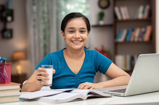 India, Indian ethnicity, teenage girl, student, drinking, milk,