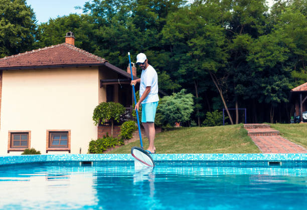 istock Man cleaning the swimming pool 1326781355