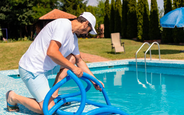 istock Man cleaning the swimming pool 1326781357