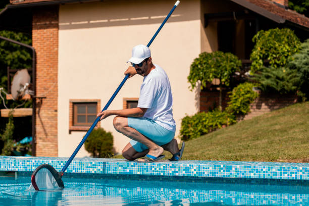 istock Man cleaning the swimming pool 1326781363