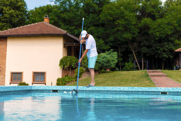istock Man cleaning the swimming pool 1326781369