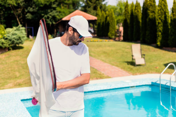 istock Man cleaning the swimming pool 1326781371