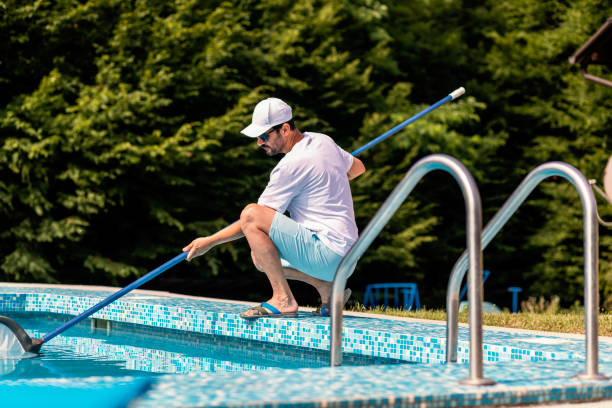 istock Man cleaning the swimming pool 1326781384