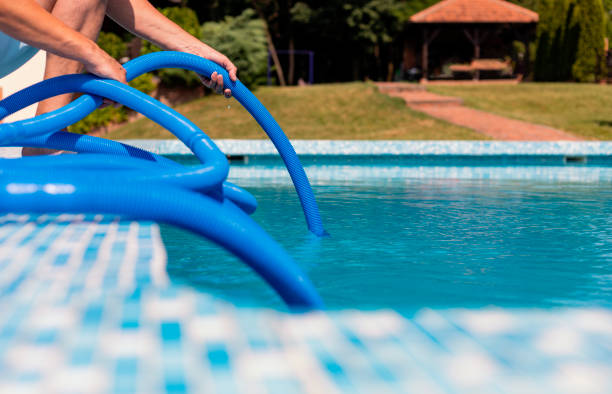 istock Man cleaning the swimming pool 1326781387
