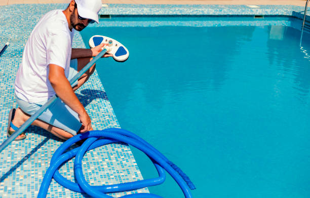 istock Man cleaning the swimming pool 1326781401