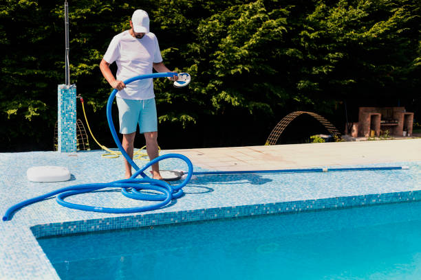 istock Man cleaning the swimming pool 1326781406