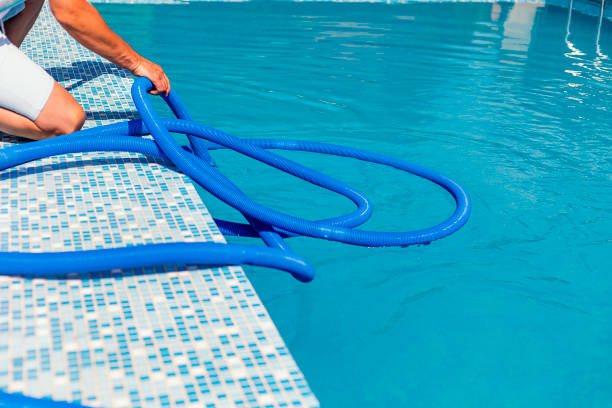 istock Man cleaning the swimming pool 1326781420