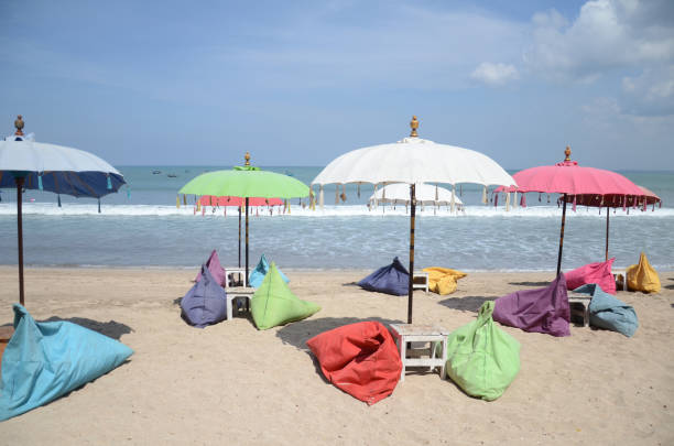 istock Empty beach background with bright tent, chairs, surf waves and sunny sky 1326783095
