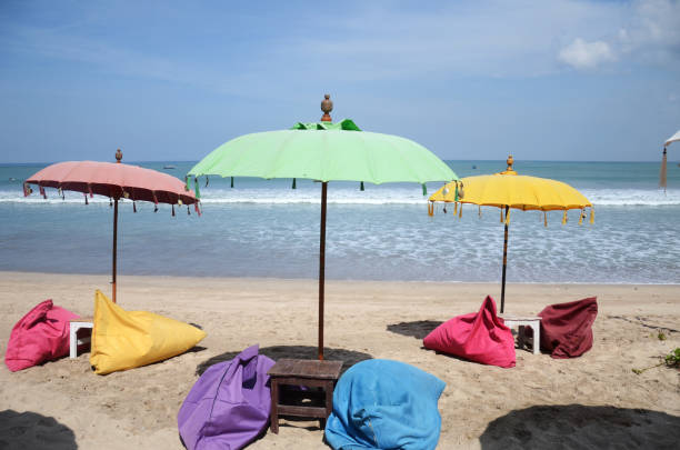 istock Empty beach background with bright tent, chairs, surf waves and sunny sky 1326783272