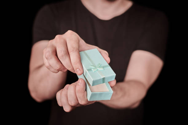 istock Man give a gift in red gift box on St. Valentine day 1326783342
