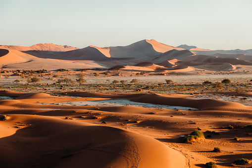 Dramatic view of the bright sunny sunrise above the beautiful remote desert at Namib-Naukluft National Park