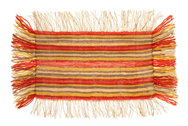 istock a small handmade rug or mat, woven from red and yellow wool threads, one object close-up 1326786759