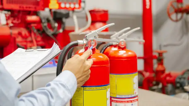 Engineer inspection Fire extinguisher and fire hose,Ready to use in the event of a fire.Safety first concept.