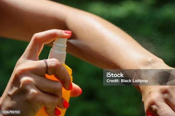 Person Spraying Mosquito Insect Repellent In The Forest Insect Protection Stock Photo - Download Image Now