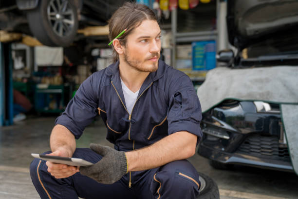 istock Service repair maintenance concept. Auto mechanic are resting and using tablet computer. 1326792000