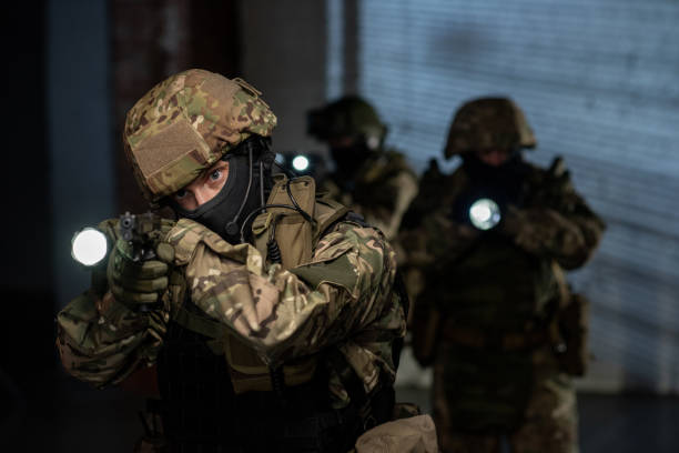 istock Terrorists with guns penetrating into office 1326792672