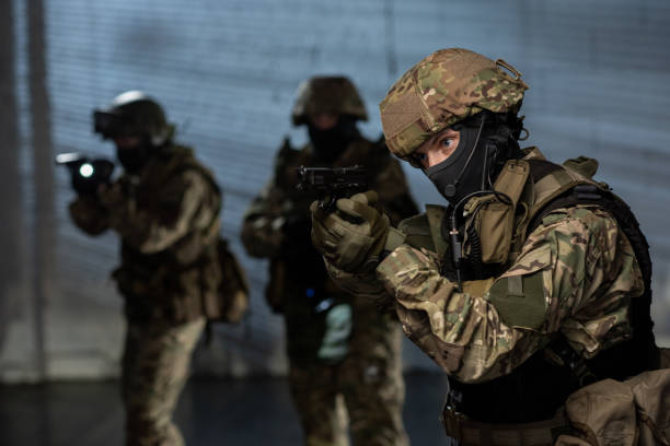istock Military men with guns coming after criminal 1326792688