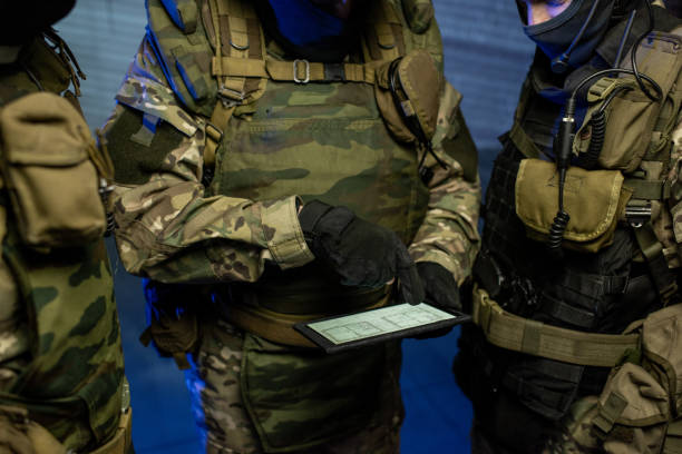 istock Three officers in camouflage outfit discussing location scheme 1326792778