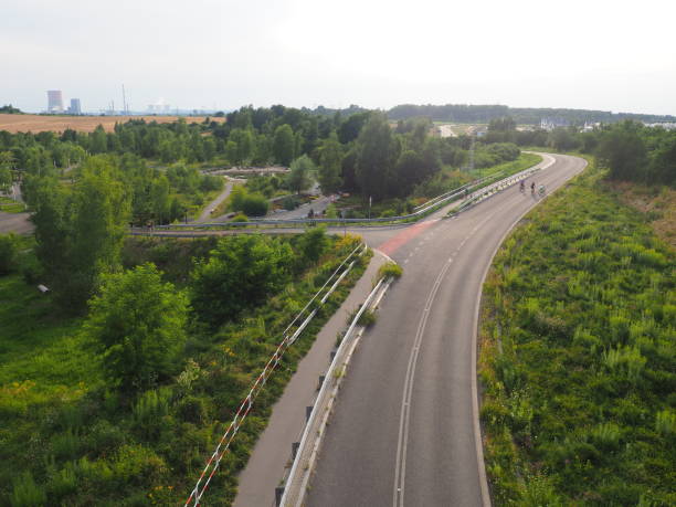 istock A large empty street between cities with greenery and a factory in the background 1326793708