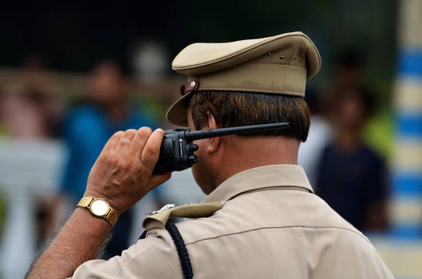 Indian police with walkie talkie Calcutta, India - August 15, 2014: Indian police with walkie talkie. Police squad the place with walkie talkie. only young men stock pictures, royalty-free photos & images