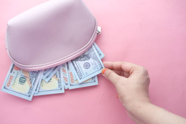 istock women hand saving cash in wallet 1326795374