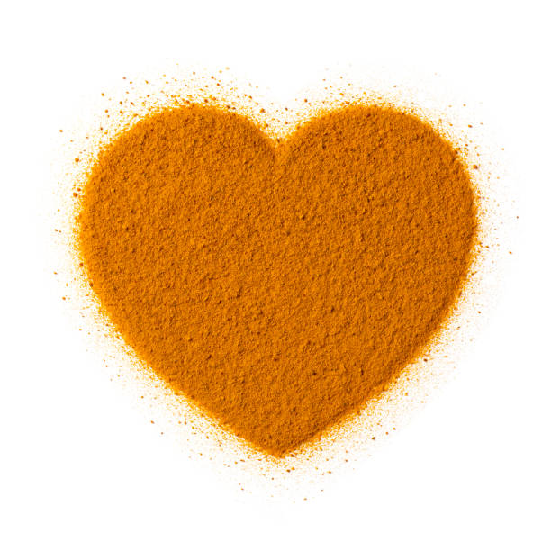 istock Turmeric powder in heart shape isolated on white background 1326796010