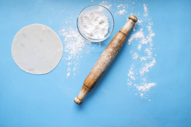 istock baking dough with rolling pin on wooden table, top view 1326796533