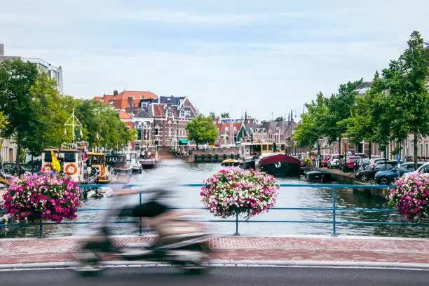 Panorama of Leiden. Famous canals and bridges with flowers on a summer afternoon.