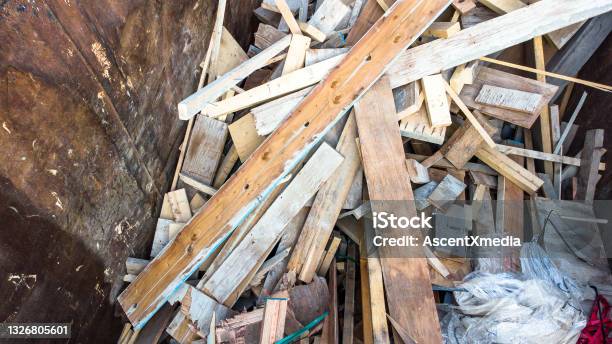 Wood Waste At A Construction Site Stock Photo - Download Image Now - Industrial Garbage Bin, Construction Site, Construction Industry
