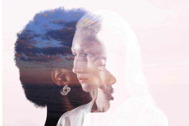 Caucasian and african american young woman isolated on black background. Caucasian woman and african american woman multiple exposure portrait on sky background. Women friendship, love and relations concept. genetic research photos stock pictures, royalty-free photos & images