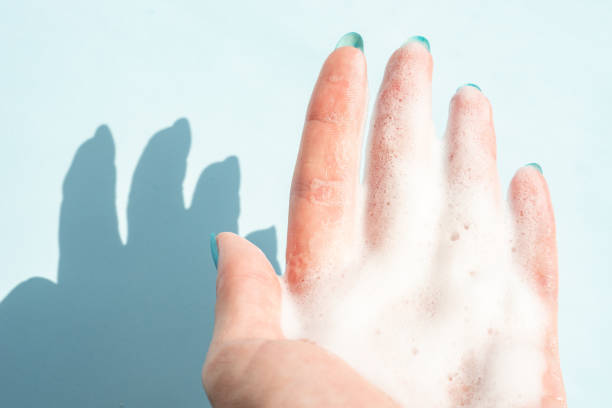 istock female hand in white foam on a blue background 1326807869