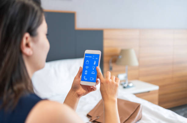 Businesswoman Using Smart Room Application On Smartphone screen İn Hotel Room Businesswoman Using Smart Room Application On Smartphone screen İn Hotel Room room service stock pictures, royalty-free photos & images