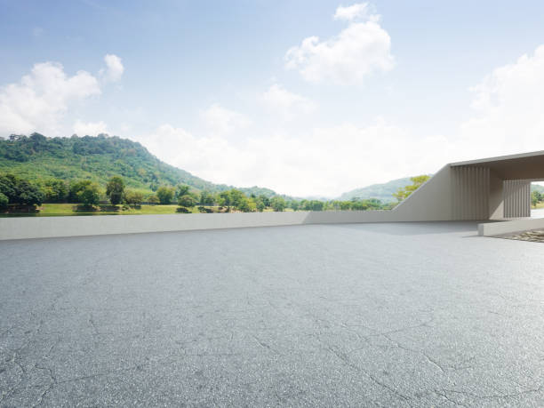 Abstract architecture design of modern building. Empty parking area floor and concrete wall with mountain and blue sky lake view. 3D rendering background image for car scene. town square stock pictures, royalty-free photos & images