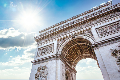 The Arc de Triomphe in Paris France on a bright summer day.