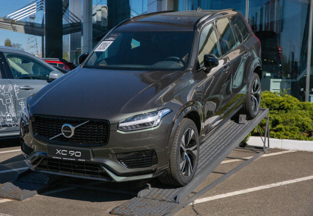 Volvo XC90 cars on display of dealership company. Kyiv, Ukraine. KYIV, UKRAINE - MAY 10, 2021: New XC90 plug-in hybrid SUV car outdoors in Volvo Winner Center dealership company. The Volvo Group is a Swedish multinational manufacturing company. volvo stock pictures, royalty-free photos & images