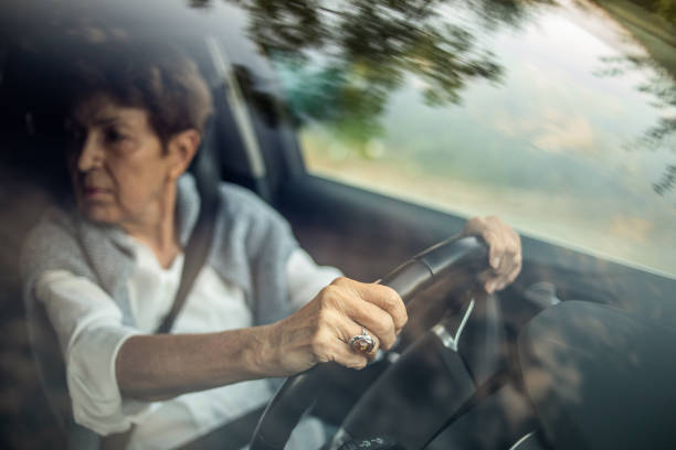 istock An elderly woman, a pensioner, drives a car. 1326819491