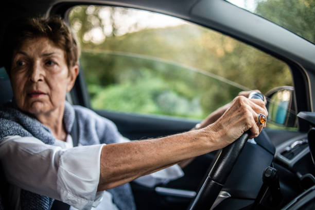 istock An elderly woman, a pensioner, drives a car. 1326819553