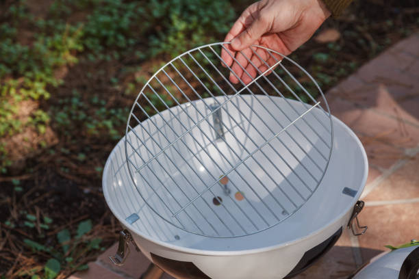 istock Hand sets grill in round barbecue 1326819699