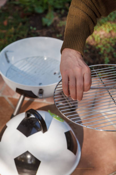 istock Hand sets grill in round barbecue 1326819730