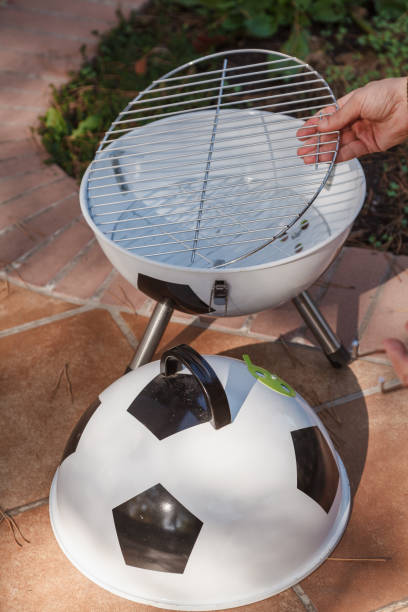 istock Hand sets grill in round barbecue 1326819746