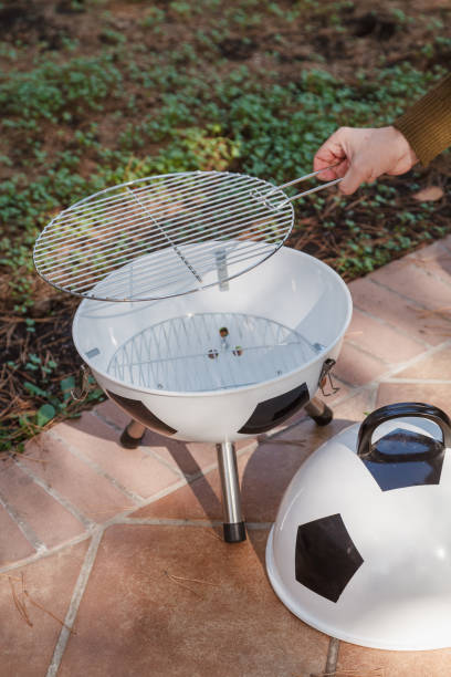 istock Hand sets grill in round barbecue 1326819780
