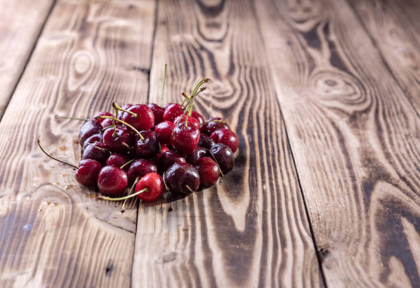 istock cherry berries are scattered on a wooden background 1326822880