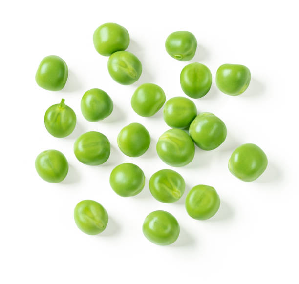 Green peas closeup isolated on white. Clipping path. Top view. Scattered fresh green peas. green pea stock pictures, royalty-free photos & images