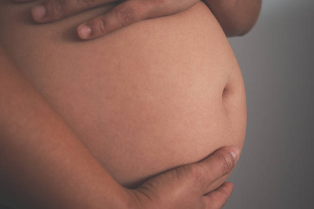 istock Mom holding her tummy during pregnancy 1326824499