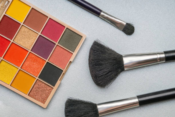 istock Shadows for the eyes of warm tones and three brushes side by side. 1326826670